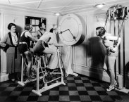 1930sNo Pain No Gain - Women exercise in a gym wearing high heels,