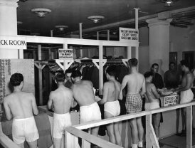 A line of underwear-clad draftees wait in line to check their clothes at an unidentified military facility, August 1944. (Photo by FPG/Getty Images)