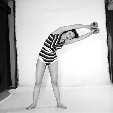 woman-exercising-with-dumb-bells-1960-news-photo-1612810682_
