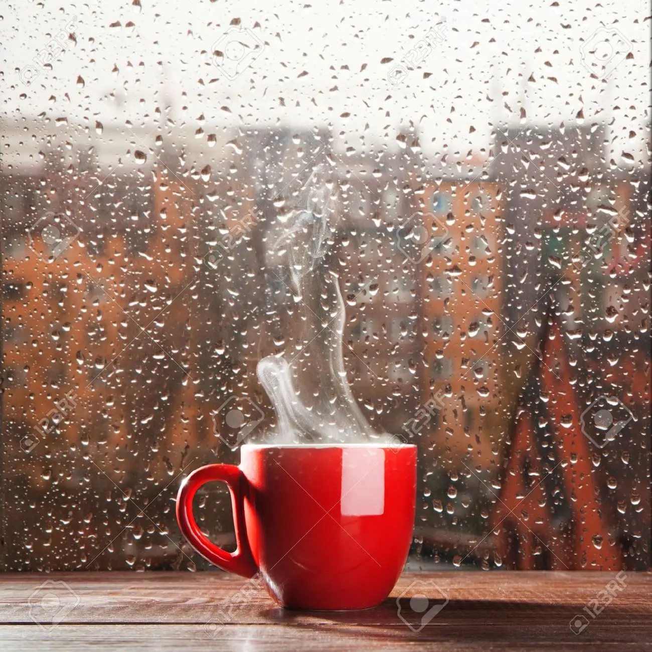 steaming-coffee-cup-on-a-rainy-day-window